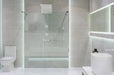 Bathroom interior with white walls, a shower cabin with glass wa