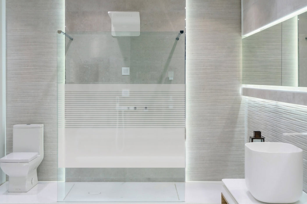 Bathroom interior with white walls, a shower cabin with glass wa