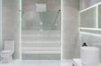 Bathroom interior with white walls, a shower cabin with glass wa