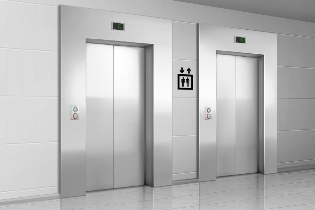 Metal elevator doors in modern office hallway